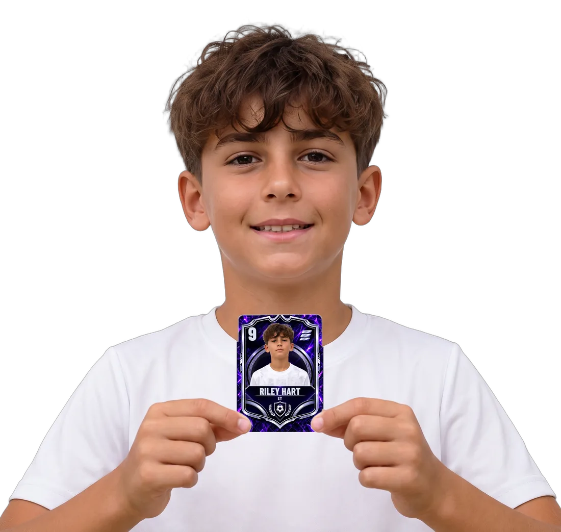 Riley Hart, a sample player, smiling and holding his personalised Royal Edition Emblem card